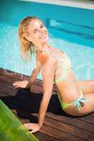 Portrait of beautiful woman sitting by poolside