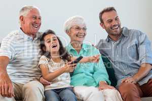 Happy family sitting on sofa