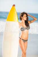 Woman holding surfboard at the beach