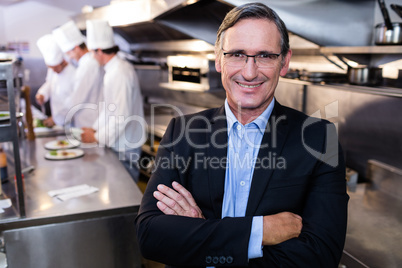 Male restaurant manager standing with arms crossed