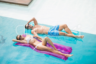 Smiling couple relaxing on inflatable raft