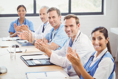 Medical team applauding in conference room