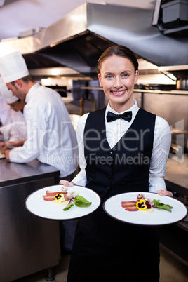 Waitress showing dishes to the camera