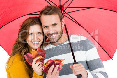 Happy young couple holding umbrella