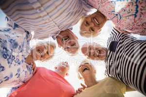 Senior friends standing in circle