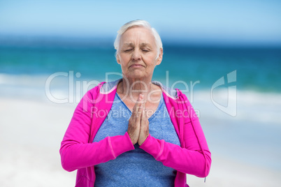 Thoughtful mature woman meditating