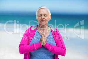 Thoughtful mature woman meditating