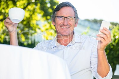Casual businessman Holding mug and smartphone Casual businessman Holding mug and smartphone