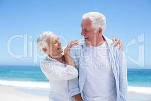 Senior couple embracing at the beach