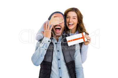 Woman giving a surprise gift to her man