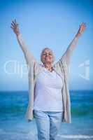 Pretty mature woman raising her arms