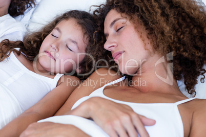 Close-up of mother and daughter sleeping together