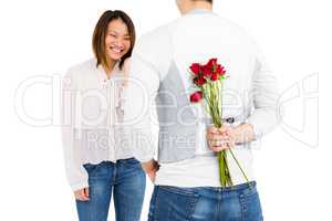 Man holding roses behind his back