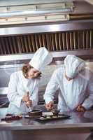 Chefs decorating a cake