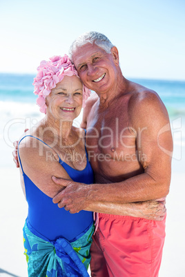 Cute mature couple hugging on the beach