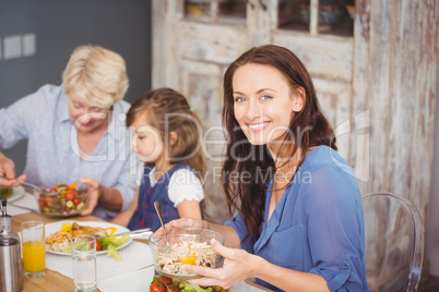 Happy woman having breakfast with family