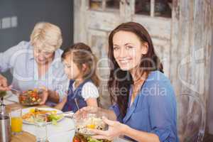 Happy woman having breakfast with family