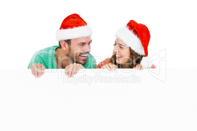 Happy young couple wearing santa hat