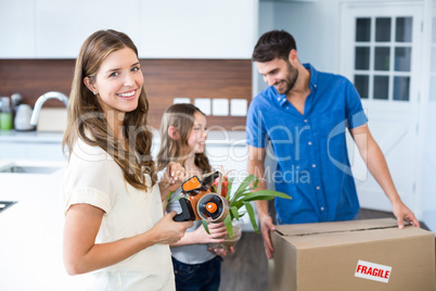 Portrait of woman helping family in packing