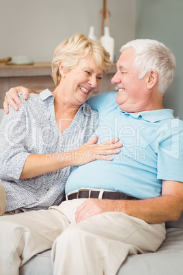 Smiling senior couple looking at eachother while hugging