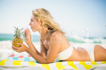 Woman drinking out of a pineapple
