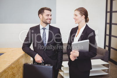Business people smiling while talking in office
