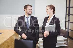Business people smiling while talking in office