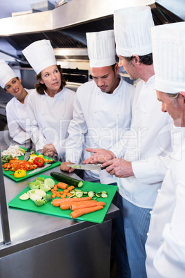 Team of chefs chopping vegetables