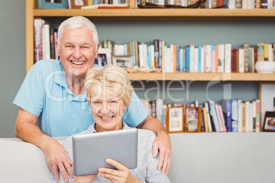 Portrait of senior couple using digital tablet