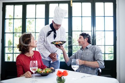 Upset man showing the food to chef