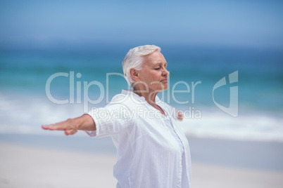 Side view of mature woman posing with outstretched arms