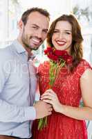Man offering flower bouquet to woman