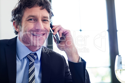 Happy businessman talking on the mobile phone