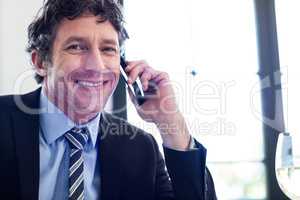 Happy businessman talking on the mobile phone
