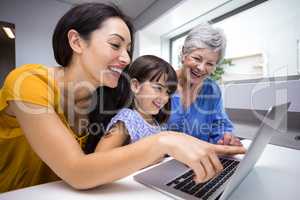 Happy family interacting using laptop