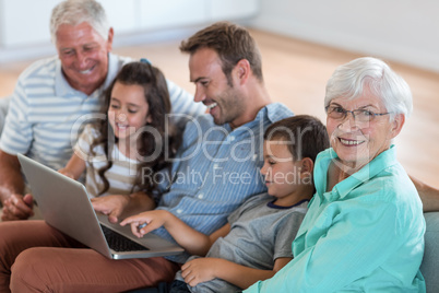 Happy family sitting on sofa