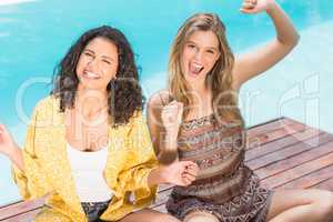 Portrait of young women having fun near pool