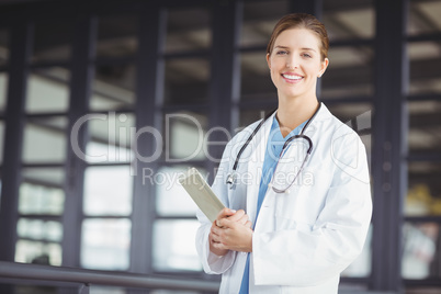 Portrait of confident female doctor holding digital tablet