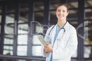 Portrait of confident female doctor holding digital tablet