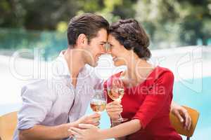 Romantic couple holding white wine