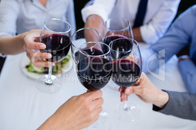 Hands toasting wine glasses