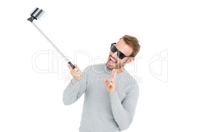 Young man taking a selfie with selfie stick