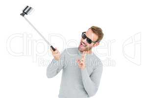 Young man taking a selfie with selfie stick