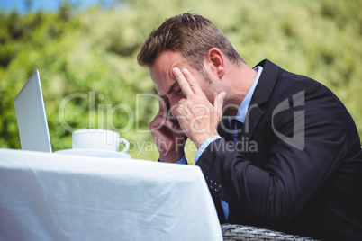 Nervous businessman working with laptop