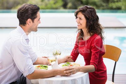 Smiling couple holding hands