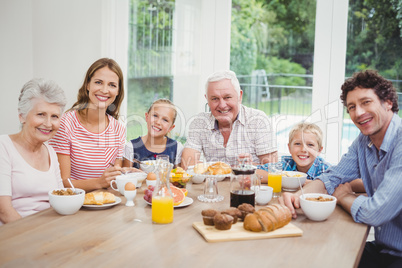 Multi-generation family sitting at table during breakfast