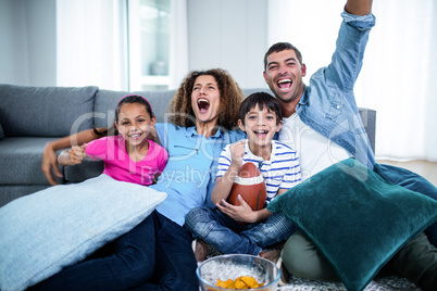 Family watching american football match on television