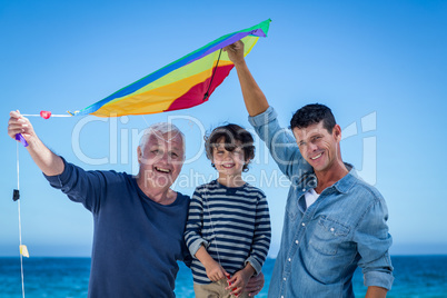 Happy multi generation family playing with a kite