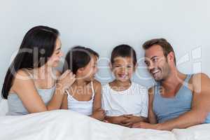 Happy family in their bedroom