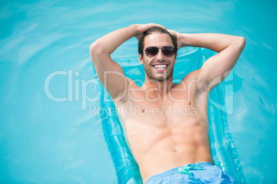 Cheerful man relaxing on inflatable raft